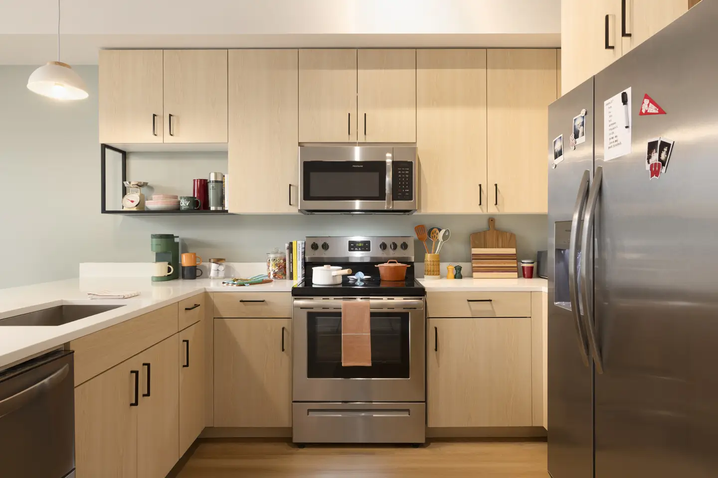 Apartment kitchen with stainless steel appliances.